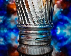 A crystal glass in front of a nebula backdrop