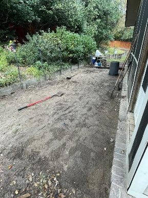 A yard being cleared with tools out
